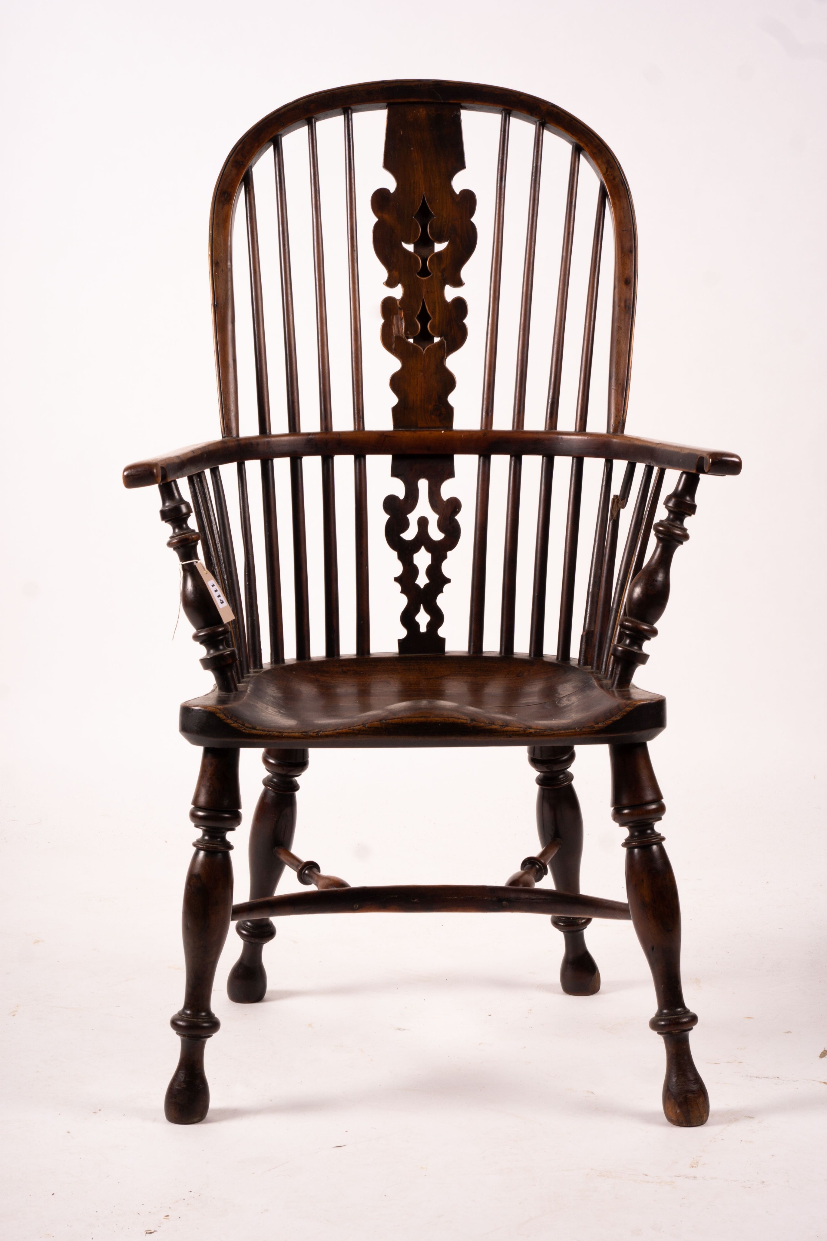 A mid 19th century yew and elm Yorkshire area Windsor armchair with saddle-seat and crinoline stretcher, width 63cm, depth 47cm, height 110cm